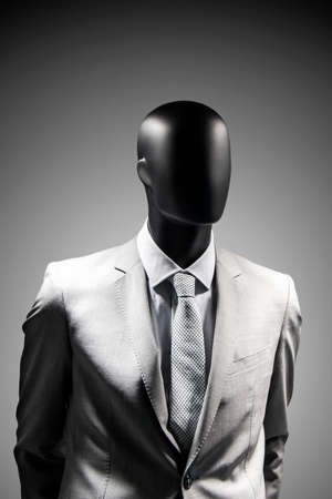 Fashion mannequin in elegant black suit over dark grey background. Black White photoの写真素材