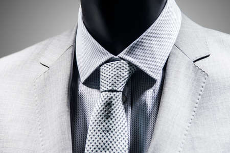 Close up of tie over elegant white suit. Black White