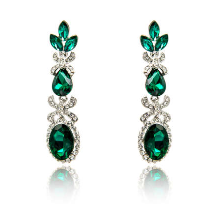 Pair of emerald earrings isolated on white backgroundの写真素材