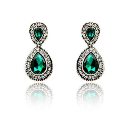 Pair of emerald earrings isolated on white backgroundの写真素材