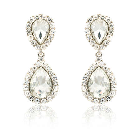 Pair of silver diamond earrings isolated on white backgroundの写真素材
