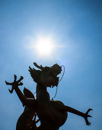 Gold chinese dragon  of thailand on blue background.の写真素材