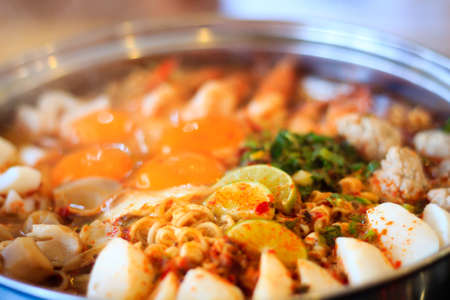 Spicy tom yum noodle with pork and seafoodの写真素材
