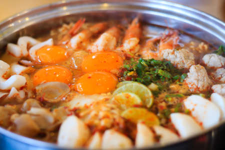 Spicy tom yum noodle with pork and seafoodの写真素材