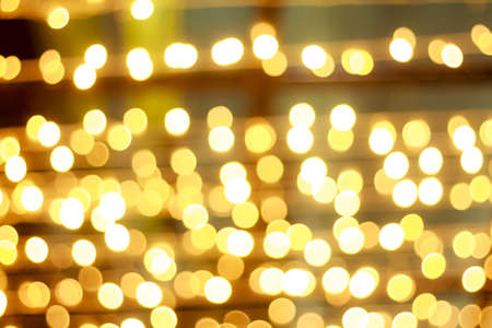 golden glitter texture and christmas bokeh on black backgroundの写真素材