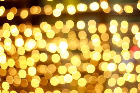 golden glitter texture and christmas bokeh on black backgroundの写真素材