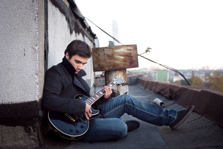  guy with a guitar on the roof