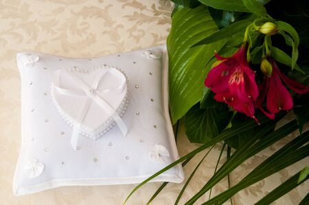 casket in the shape of a heart on the pillowの写真素材