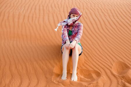 Young woman in the desert  United Arab Emiratesの写真素材
