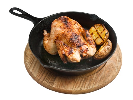 Baked chicken with potatoes over white backgroundの写真素材