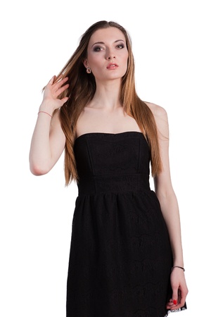 Attractive young woman in a black dress smiling and looking at camera.の写真素材