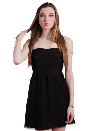 Attractive young woman in a black dress smiling and looking at camera.の写真素材