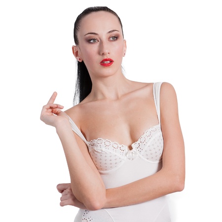 Portrait of young lady standing in lingerie against white backgroundの写真素材