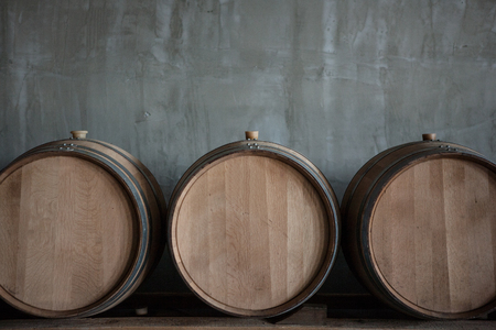 Wine barrels stacked in the cellar of the wineryの写真素材