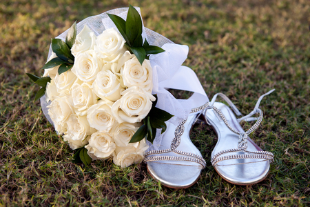 Bridal bouquet on the grass near sandalsの写真素材