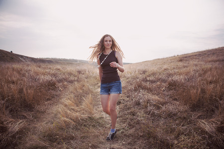 Young girl walking in a fieldの写真素材