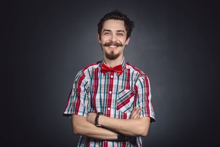 Man in plaid shirt and bow tie in the studioの写真素材