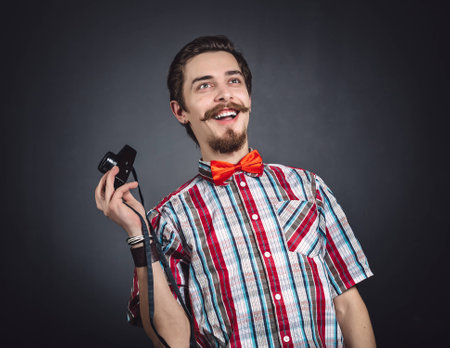 Portrait of a cheerful photographer in studioの写真素材