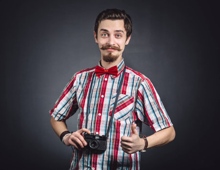 Portrait of a cheerful photographer in studioの写真素材