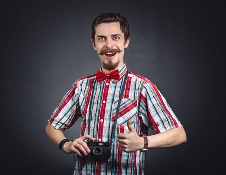 Portrait of a cheerful photographer in studioの写真素材