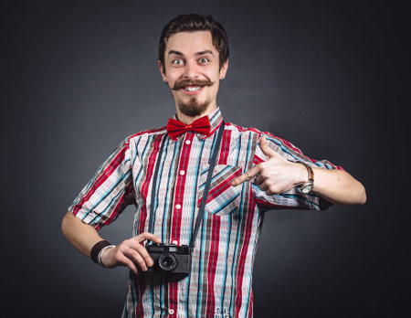 Portrait of a cheerful photographer in studioの写真素材