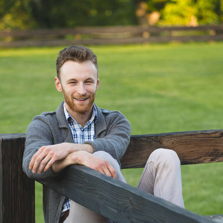 Portrait of handsome young man smiling outdoorsの写真素材