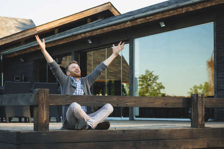 Portrait of handsome young man smiling outdoorsの写真素材
