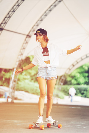 Fashion lifestyle, beautiful young woman with longboard.   の写真素材