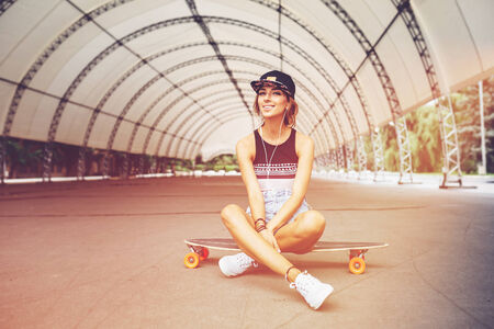 Fashion lifestyle, beautiful young woman with longboard.    の写真素材