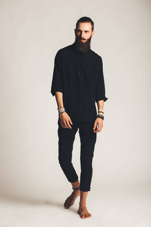 Young handsome man in black shirt on white backgroundの写真素材