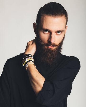 Young handsome man in black shirt on white background