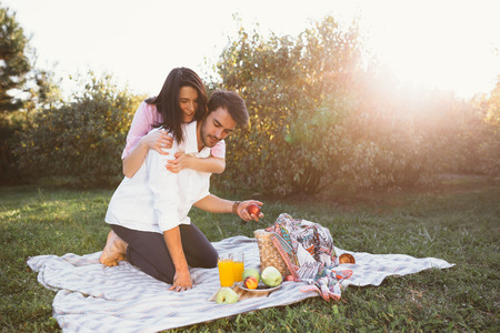 Pregnant couple on picnicの写真素材