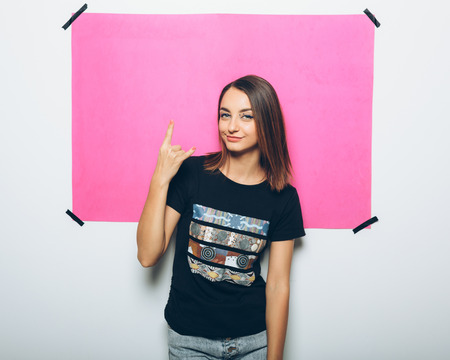 Cheerful girl in casual clothes posing at cameraの写真素材