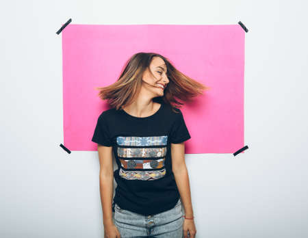 Cheerful girl in casual clothes posing at cameraの写真素材