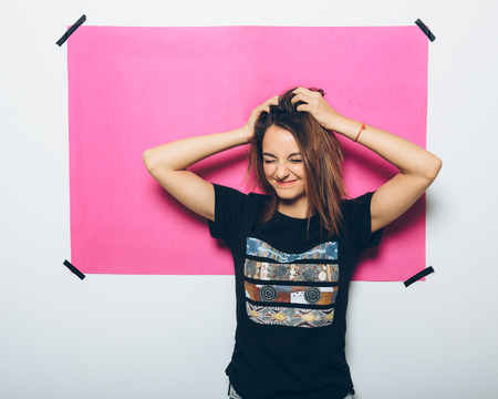 Cheerful girl in casual clothes posing at cameraの写真素材
