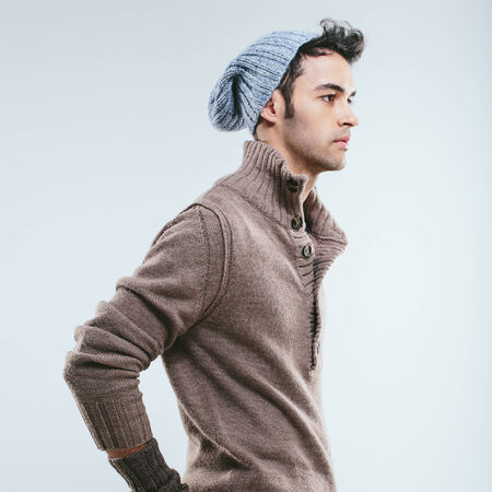 Fashionable man in winter knitted clothes. Studio portraitの写真素材