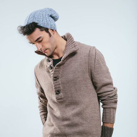Fashionable man in winter knitted clothes. Studio portraitの写真素材