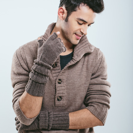 Fashionable man in winter knitted clothes. Studio portraitの写真素材