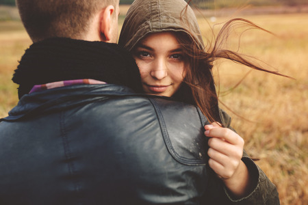 Landscape portrait of young beautiful stylish couple sensual and having fun outdoor. Film effectの写真素材