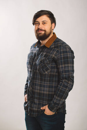 Guy in a plaid shirt over white backgroundの写真素材