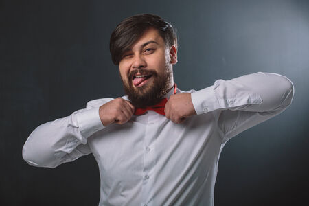 Portrait of a guy in white shirt with red tie bowの写真素材