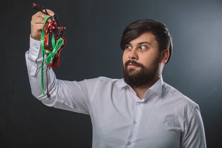 Portrait of a guy in white shirt with colorful bow tiesの写真素材