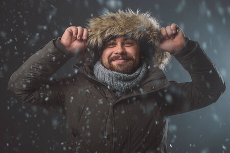 Handsome bearded man in snow stormの写真素材