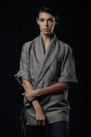 Fashion photo of young magnificent woman in grey shirt. Girl posing. Studio photoの写真素材