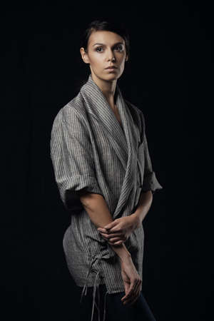 Fashion photo of young magnificent woman in grey shirt. Girl posing. Studio photoの写真素材