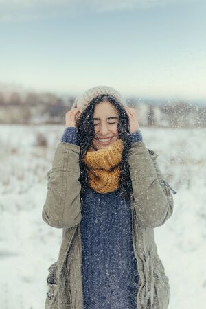 Attractive young woman having fun in wintertime outdoorの写真素材