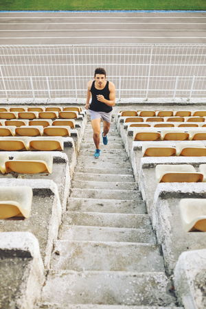 Athletic man running on stairsの写真素材