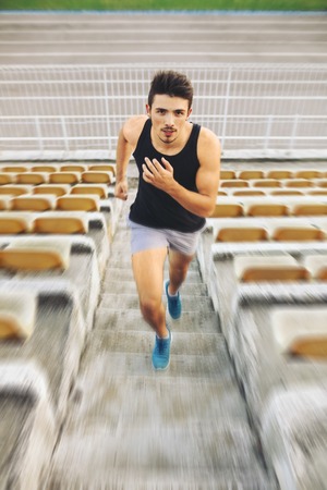 Athletic man running on stairsの写真素材