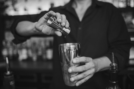 Barman at work in the pub making cocktails. Black and white photoの写真素材