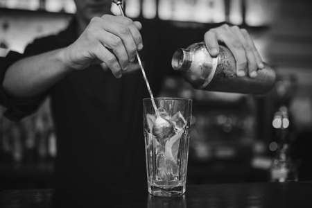 Barman at work in the pub making cocktails. Black and white photoの写真素材